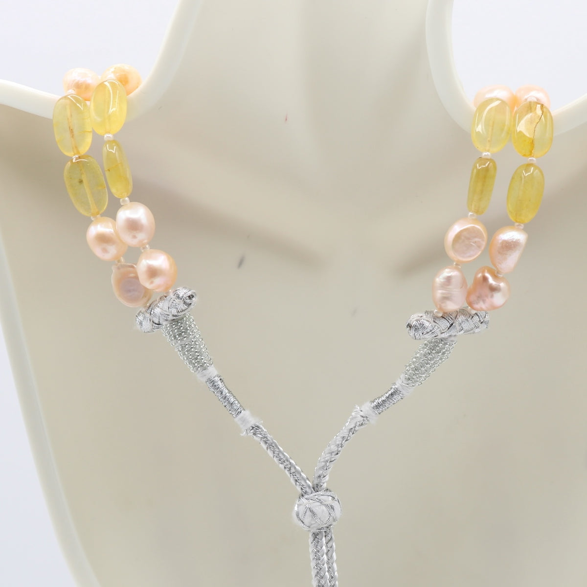 Fresh Water Pearl with Bi-Color Jade necklace featuring a multi-strand design and elegant charm.