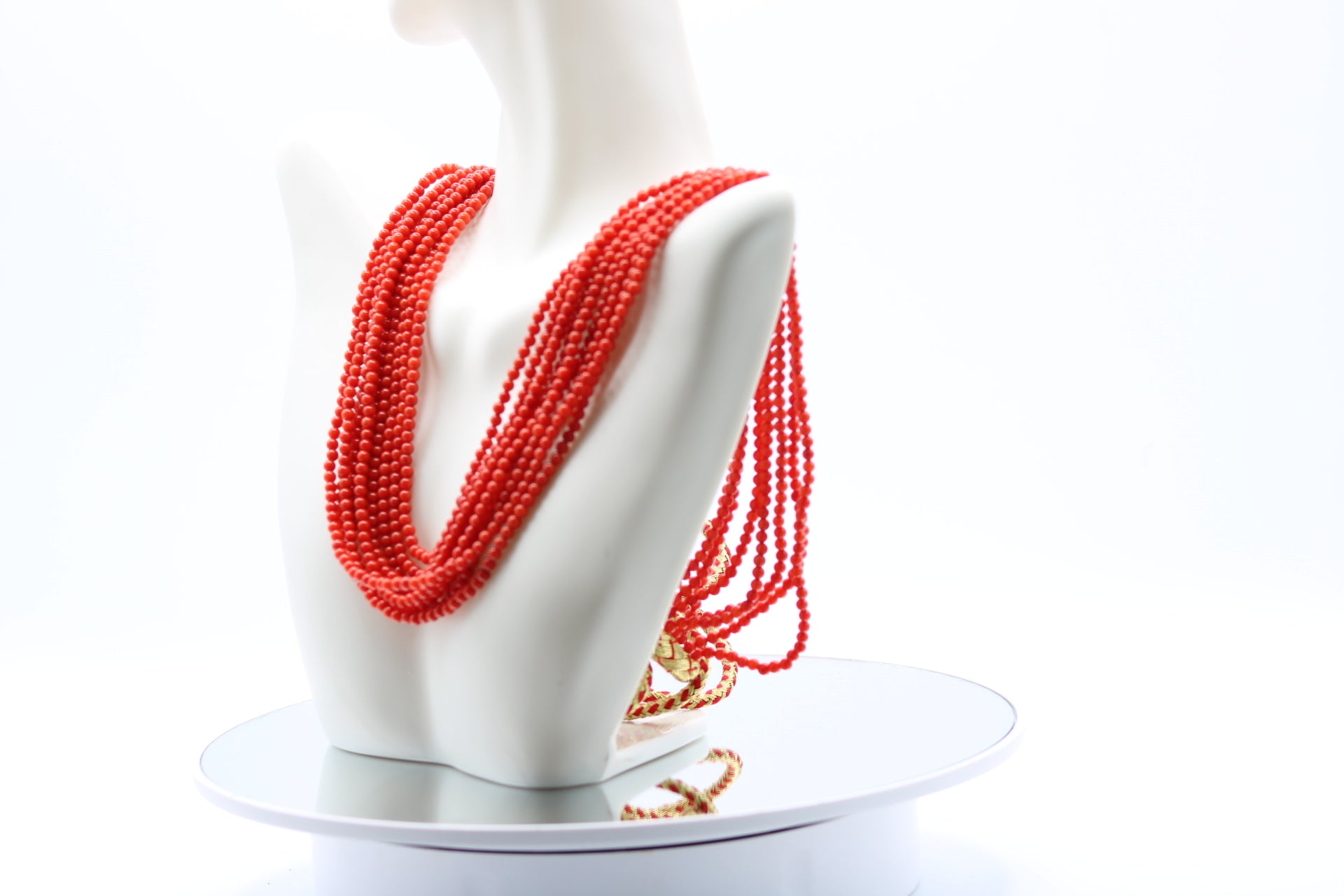 Coral Necklace 3mm - 10 Strands displayed on a bust mannequin in reddish-orange tones.