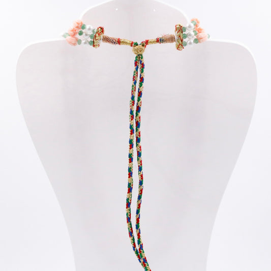 Back view of Coral Shell Pearl & Quartz Beaded Necklace showcasing colorful braided tassels and intricate beading.