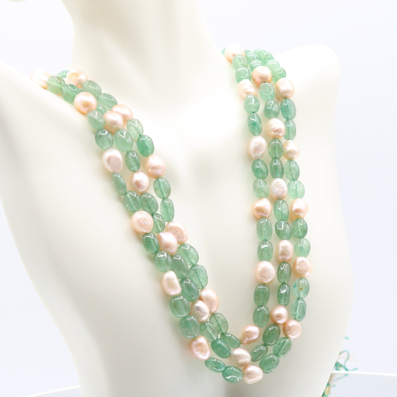 Layered necklace featuring Russian Emerald and pearl beads, showcasing a blend of green quartz and pearls.