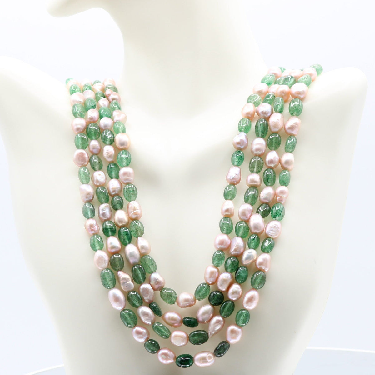 Layered necklace featuring Russian Emerald and pearl beads, perfect for amplifying your energy with elegance.