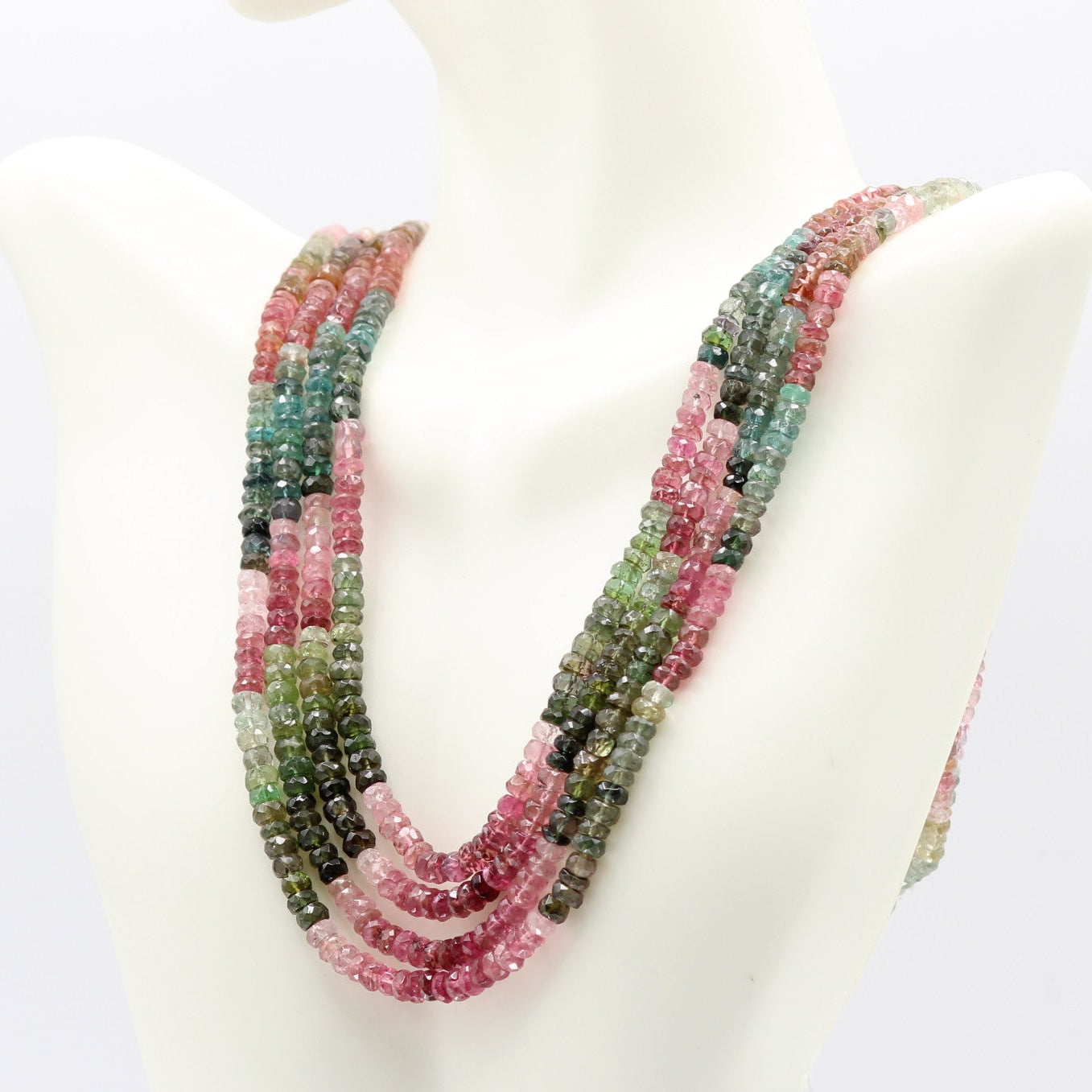 Tourmaline multi color faceted necklace displayed on a mannequin, showcasing vibrant gemstones in various hues.