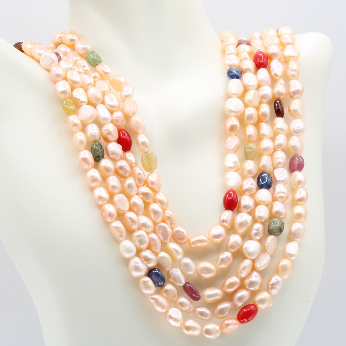 Pearl with Navratna Layered Necklace featuring multi-strands of fresh water pearls and colorful gemstones.
