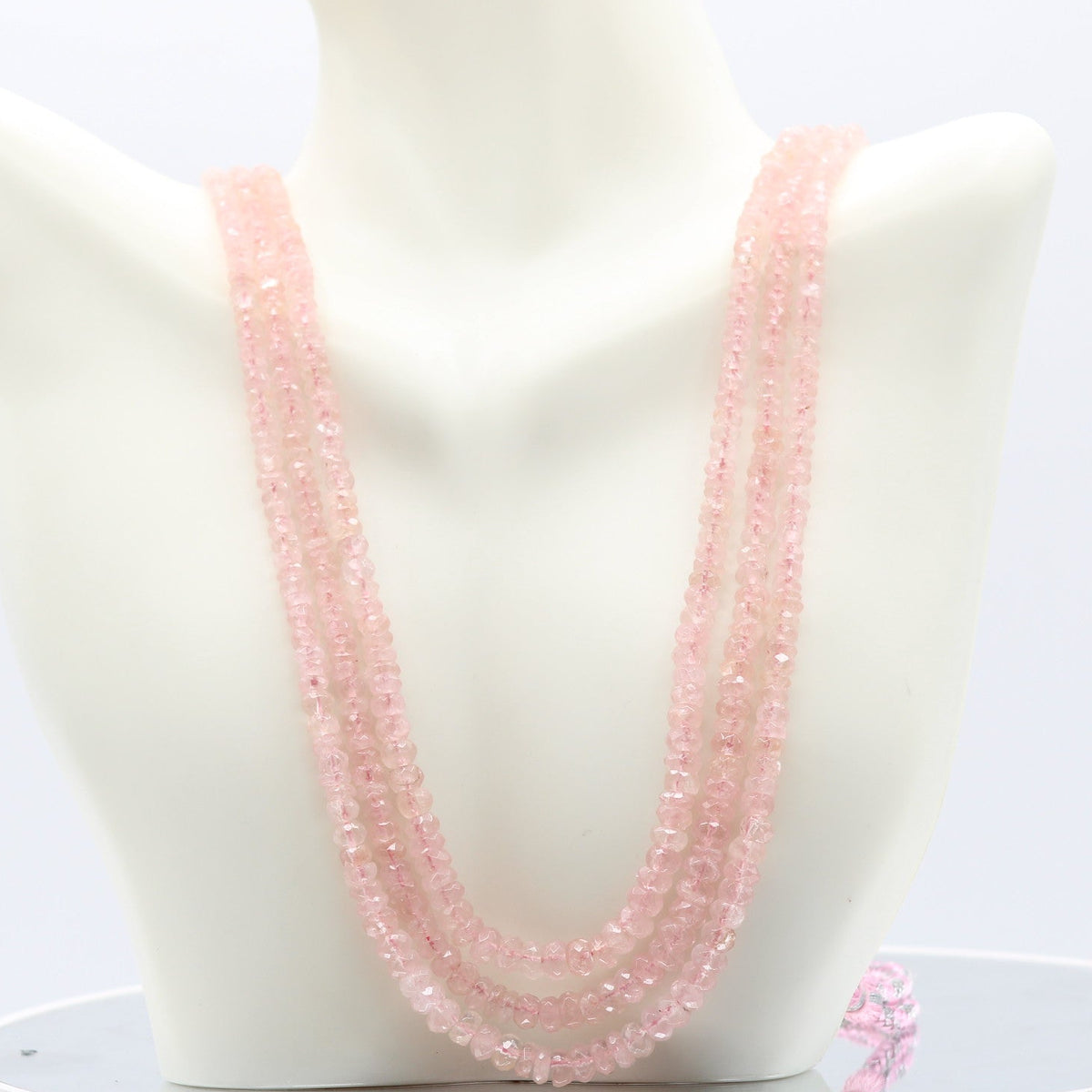 Morganite faceted necklace displayed on a mannequin, showcasing its beautiful pink hue.