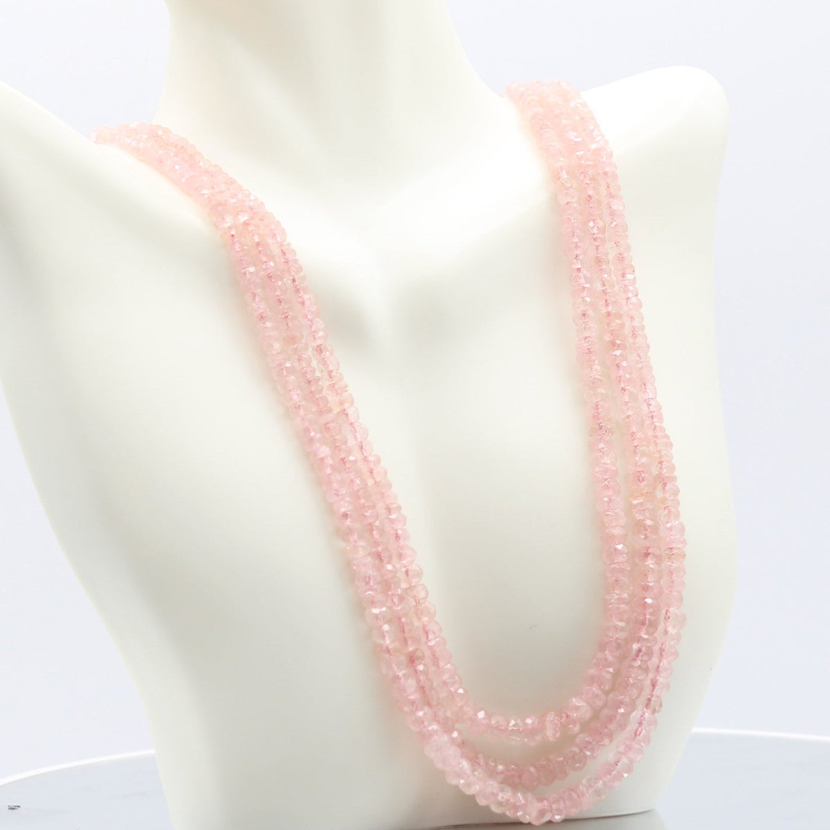 Morganite faceted necklace displayed on a mannequin, showcasing its beautiful pink hues and elegant design.
