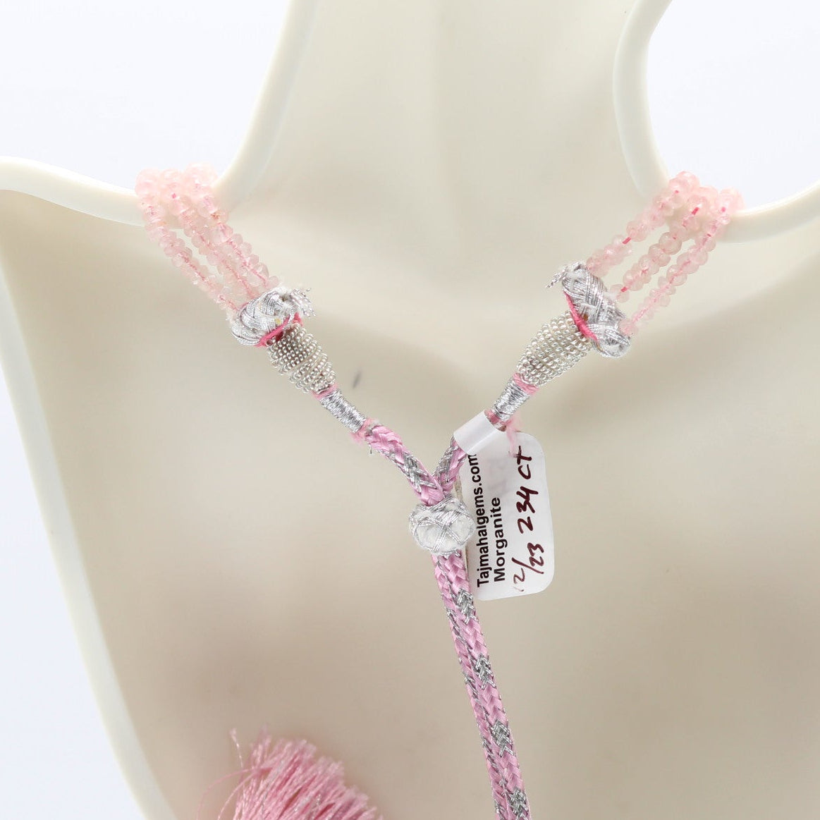 Morganite faceted necklace with pink accents and silver details showcased on a display bust.
