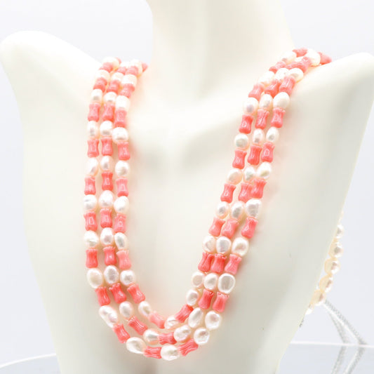 Pink Coral & Fresh Water Pearl Necklace featuring coral and pearls, showcasing a vibrant, elegant design.