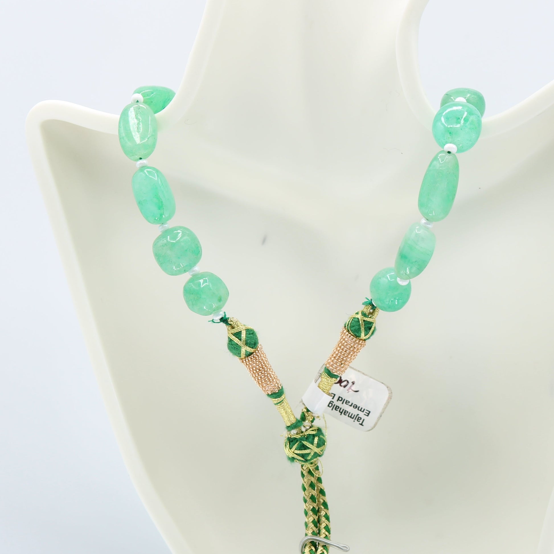 Emerald necklace featuring natural emerald beryl in bluish green nuggets with a unique clasp design.