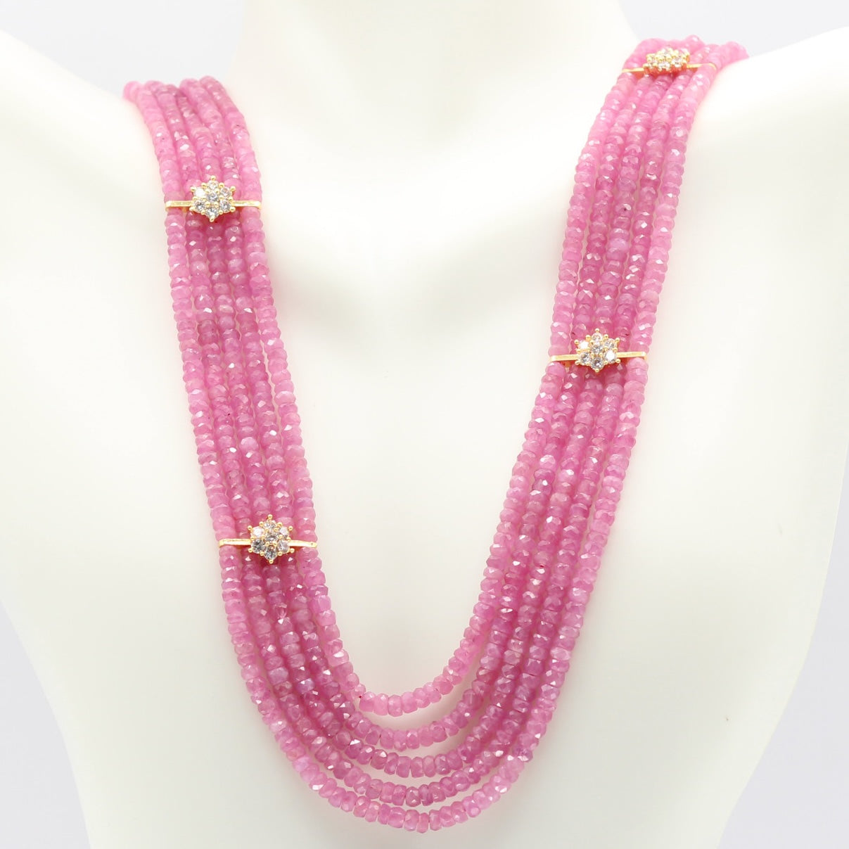 Natural Pink Sapphire Bead Necklace with sparkling accents on a display mannequin.
