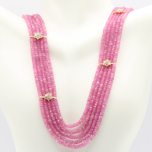 Natural Pink Sapphire Bead Necklace with sparkling accents on a display mannequin.