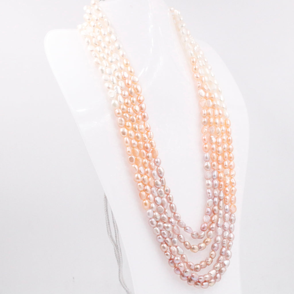 Multi-strand necklace featuring shaded pearls in a beaded style