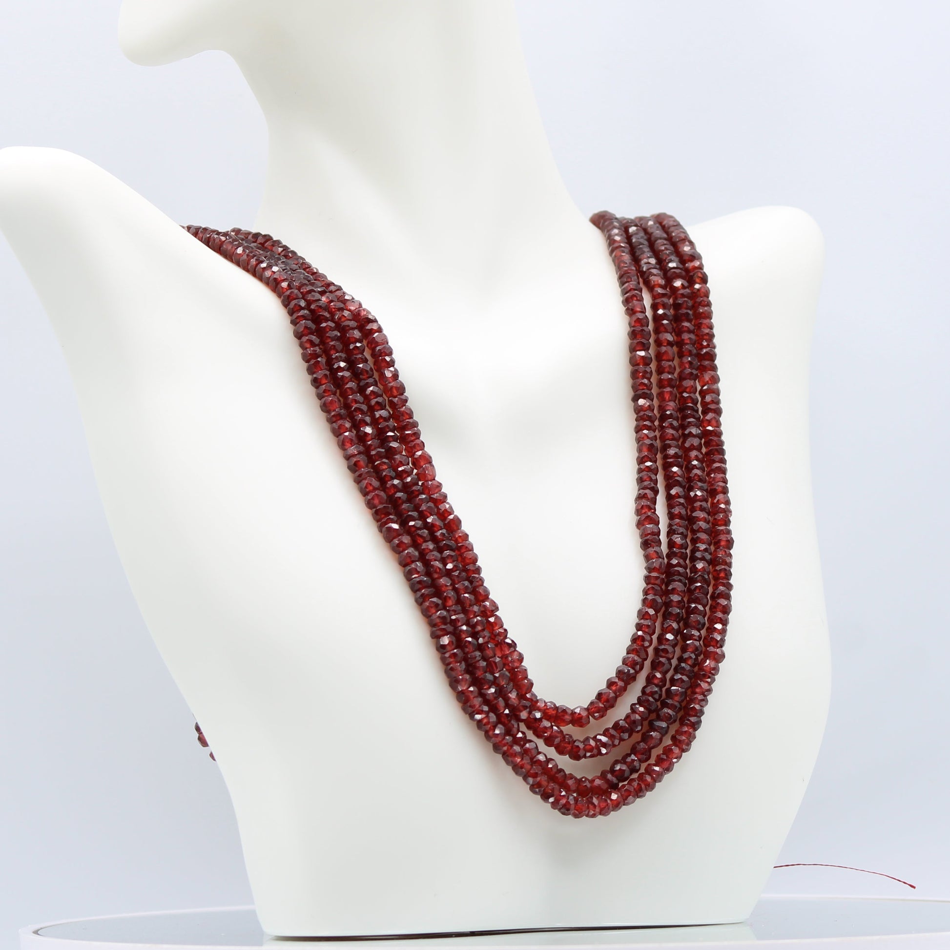 Rhodolite Garnet Beaded Necklace featuring 4 strands of deep rose red garnets, showcasing brilliance and elegance.