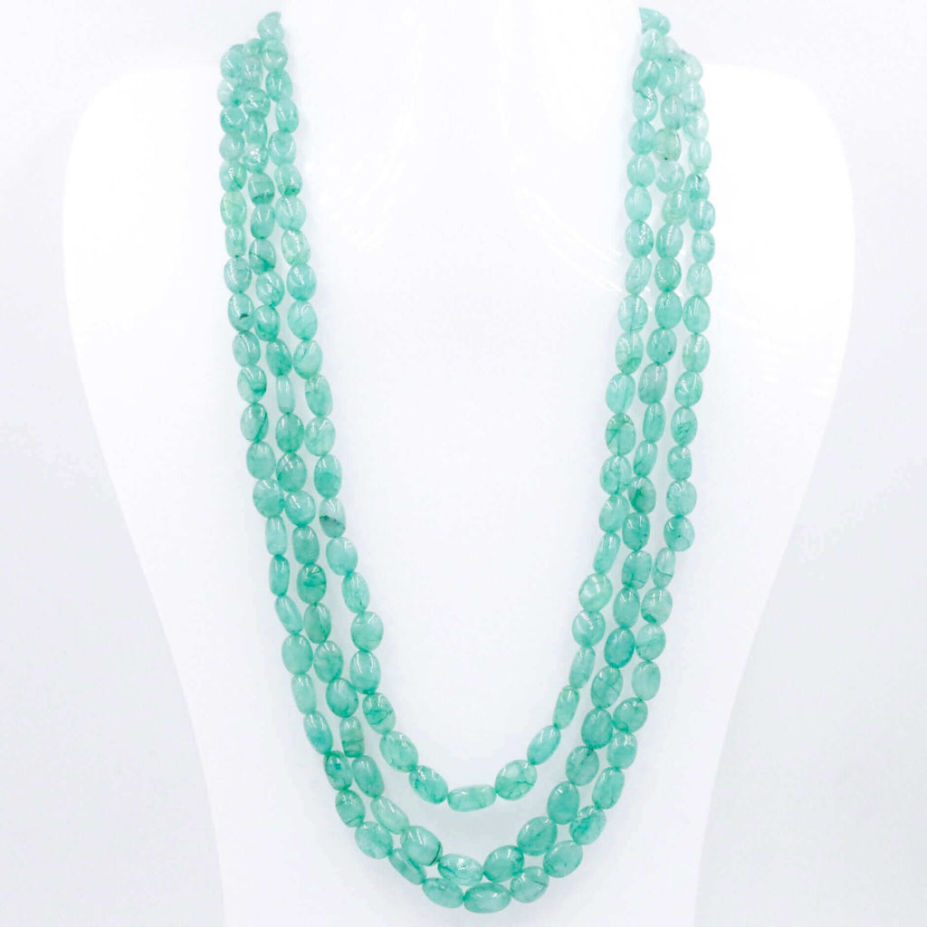 Layered necklace with multiple strands of green quartz beads