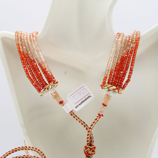 Multi-Color CZ Necklace featuring 7 strands of faceted roundelle cubic zirconia in orange and brown shades.
