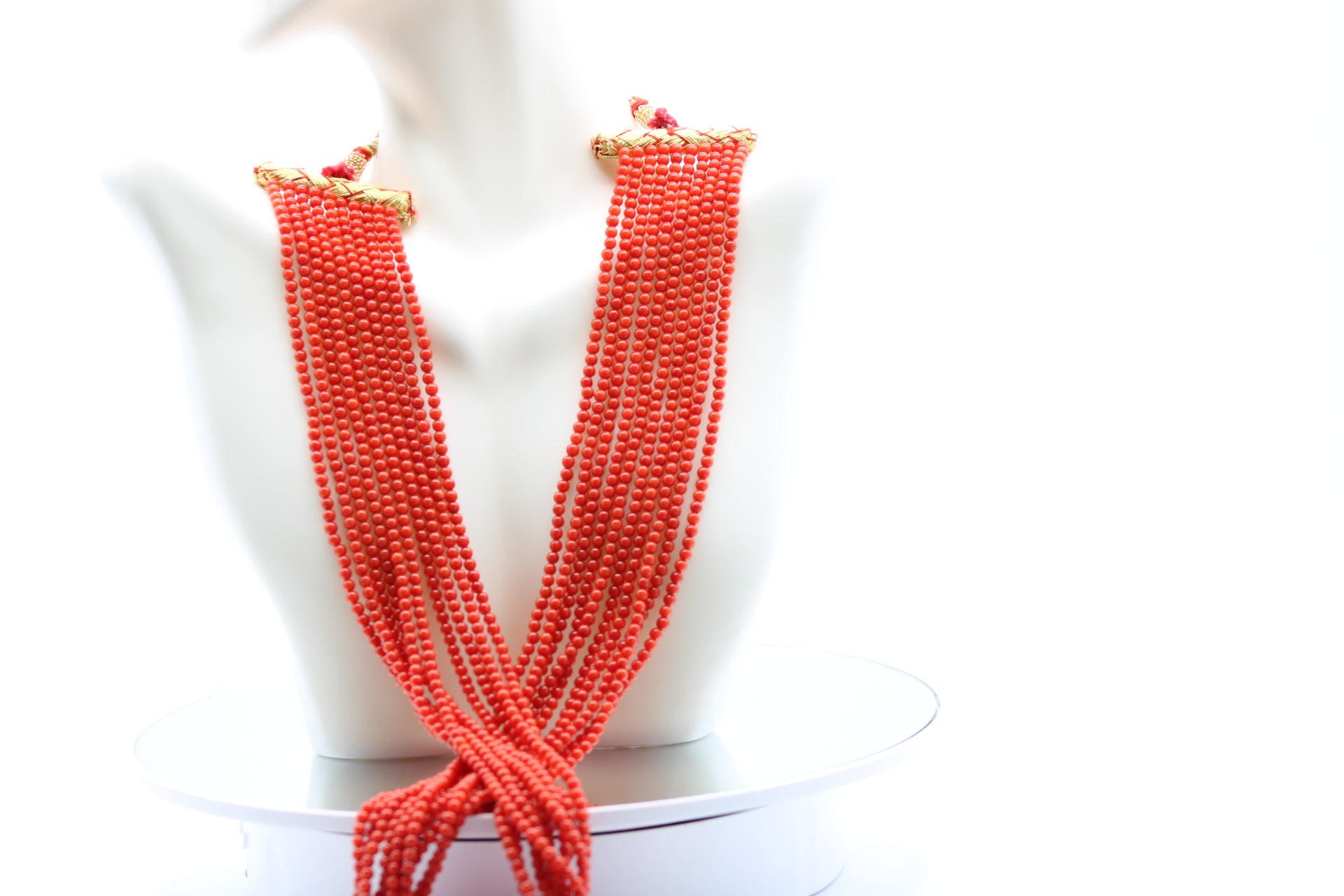 Coral Necklace 3mm - 10 Strands featuring multiple strands of polished reddish-orange coral gemstones.
