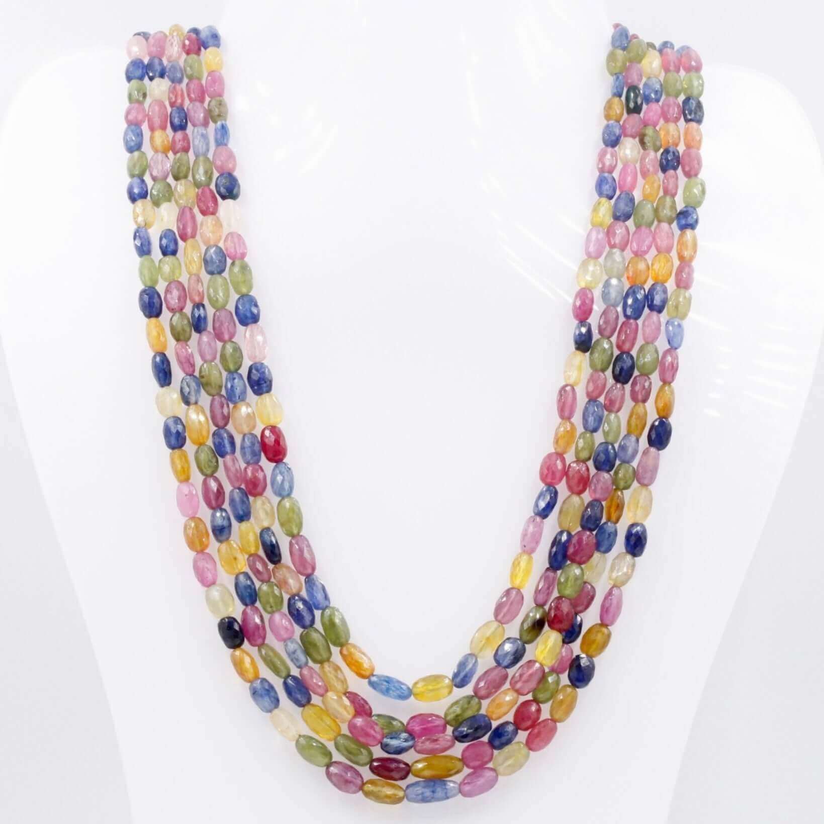 multicolor sapphire ruby necklace featuring vibrant gemstones in various colors and shapes on display.