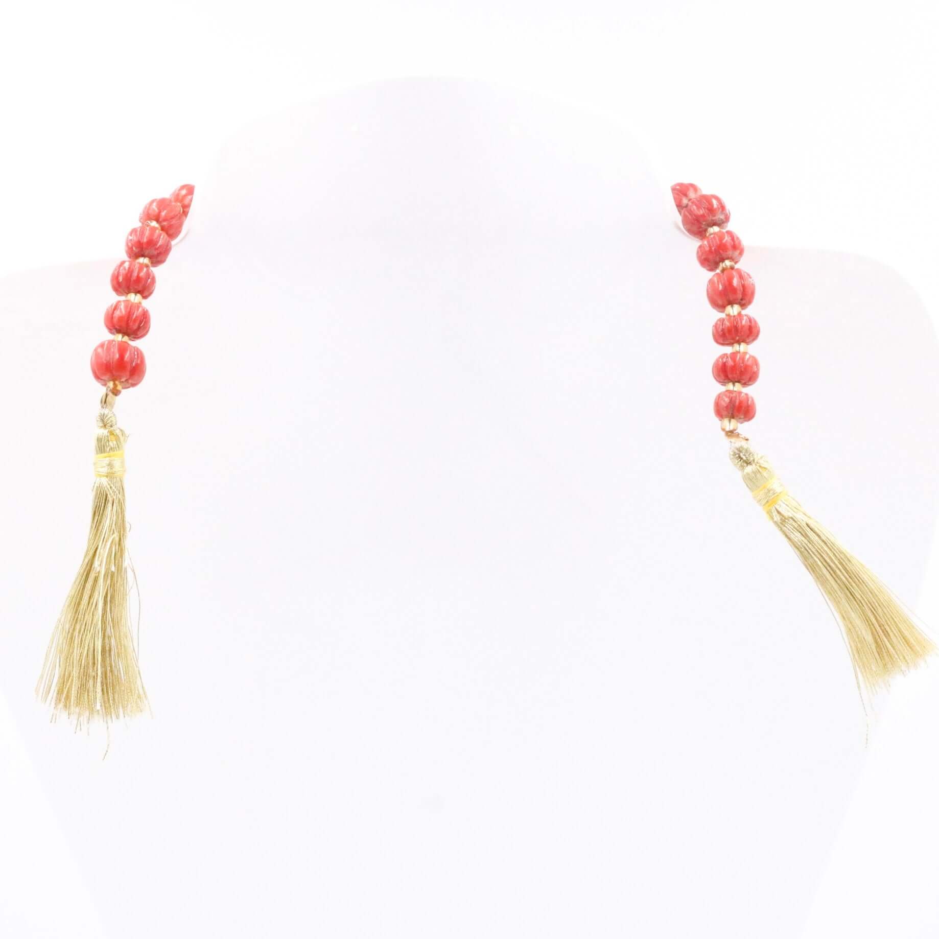 Natural Italian coral beads necklace with golden tassels, known for promoting mental peace and vitality.