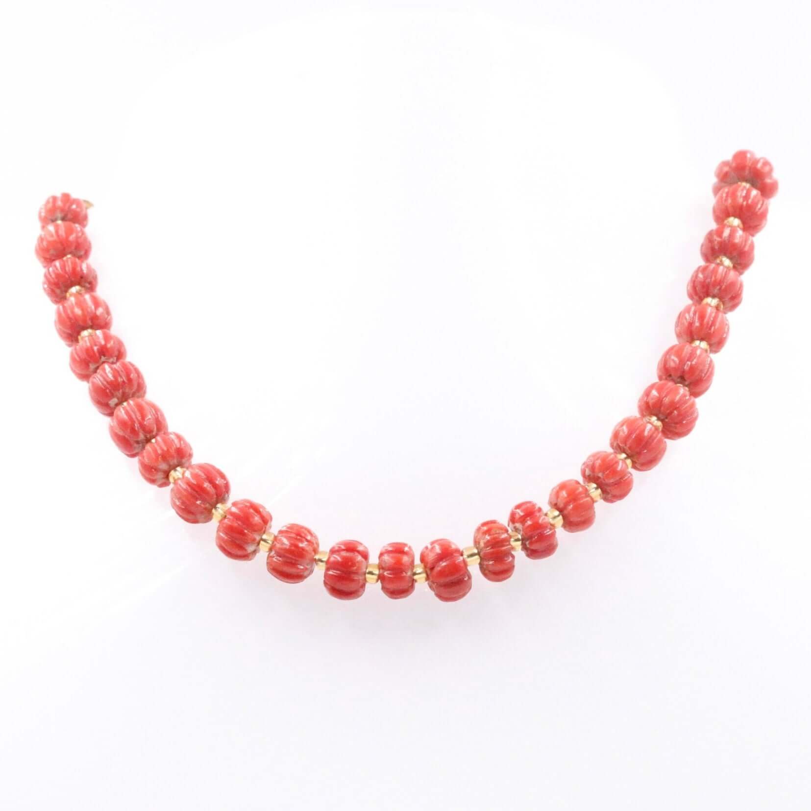 Natural Italian coral beads pumpkin strand showcasing vibrant red coral beads with gold accents.