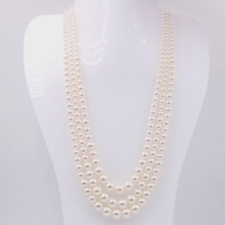 a white mannequin wearing Pearl Necklace