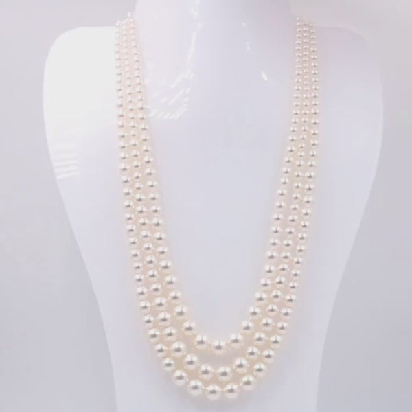 a white mannequin wearing Pearl Necklace