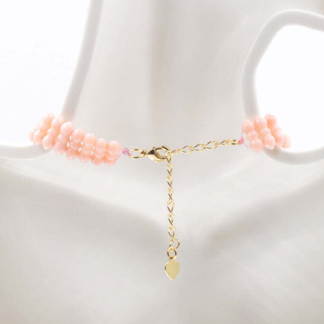 natural coral beaded necklace with light peachy pink beads and gold clasp, perfect for luck and fortune.