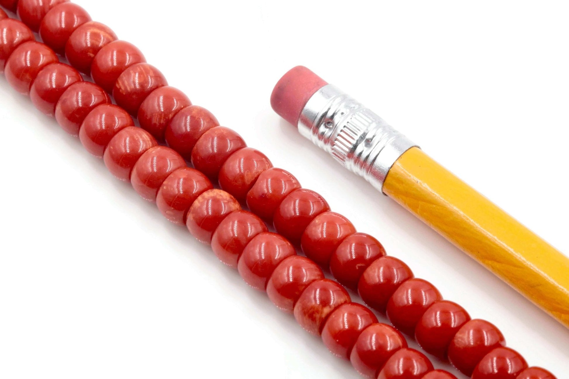 Coral Beads - Natural Antique Italian Red Coral Strand with a pencil and eraser in the image.