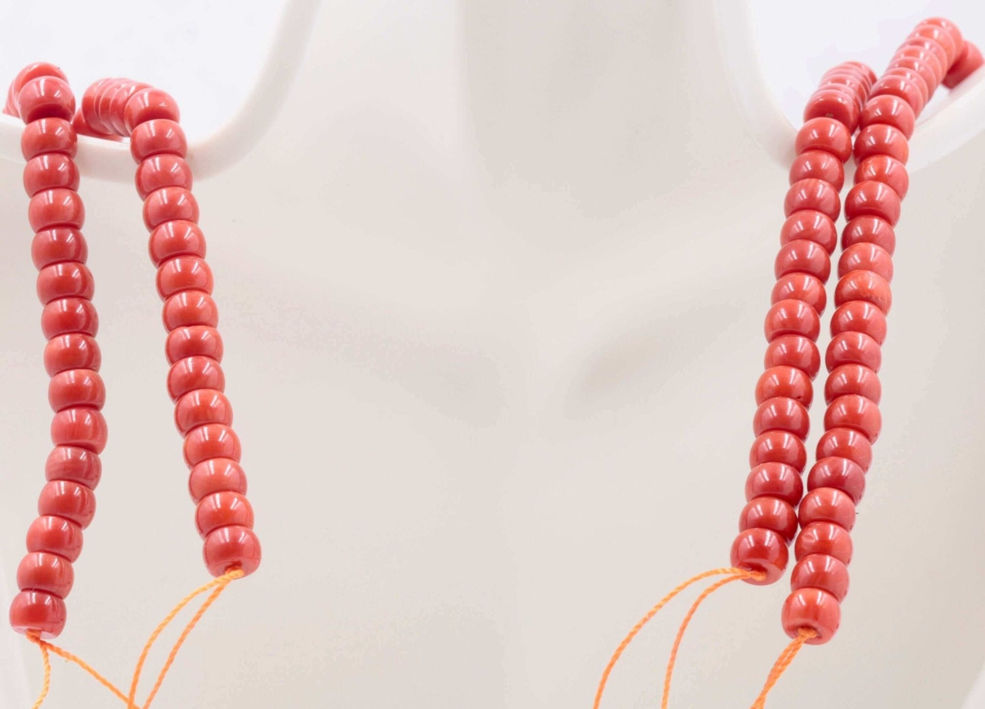 Coral Beads - Natural Antique Italian Red Coral Strand displayed on a mannequin with multiple strands of beads.