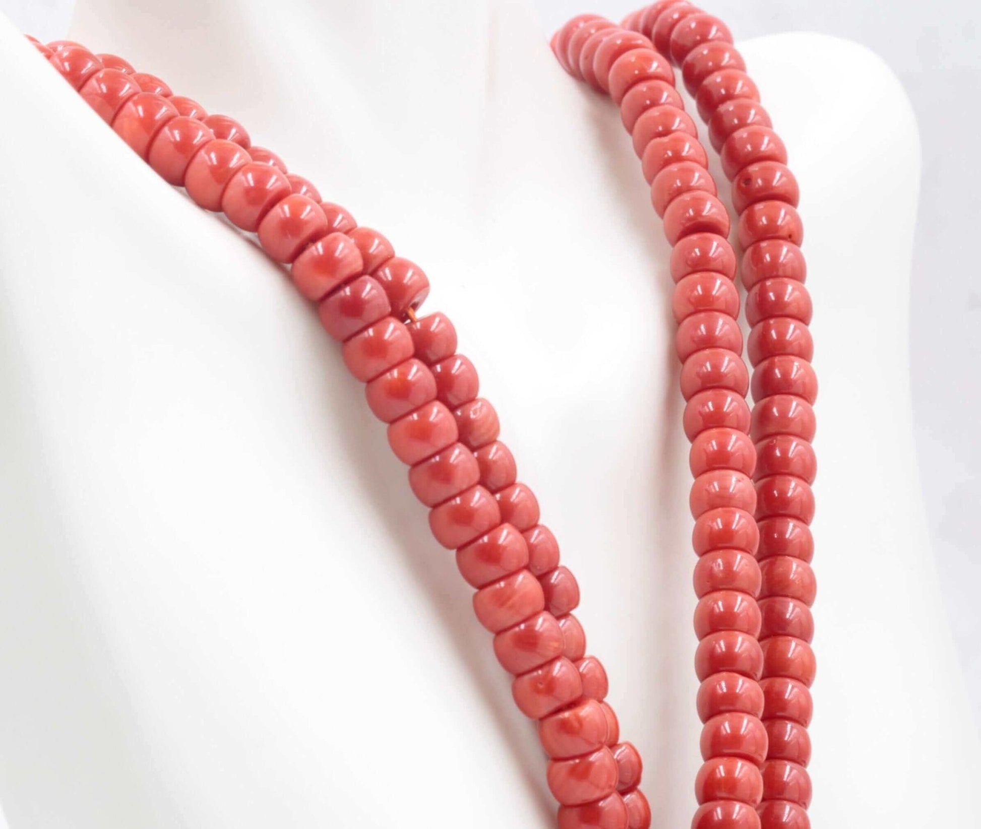 Coral Beads - Natural Antique Italian Red Coral Strand displayed on a mannequin, showcasing the vibrant red color and smooth texture.