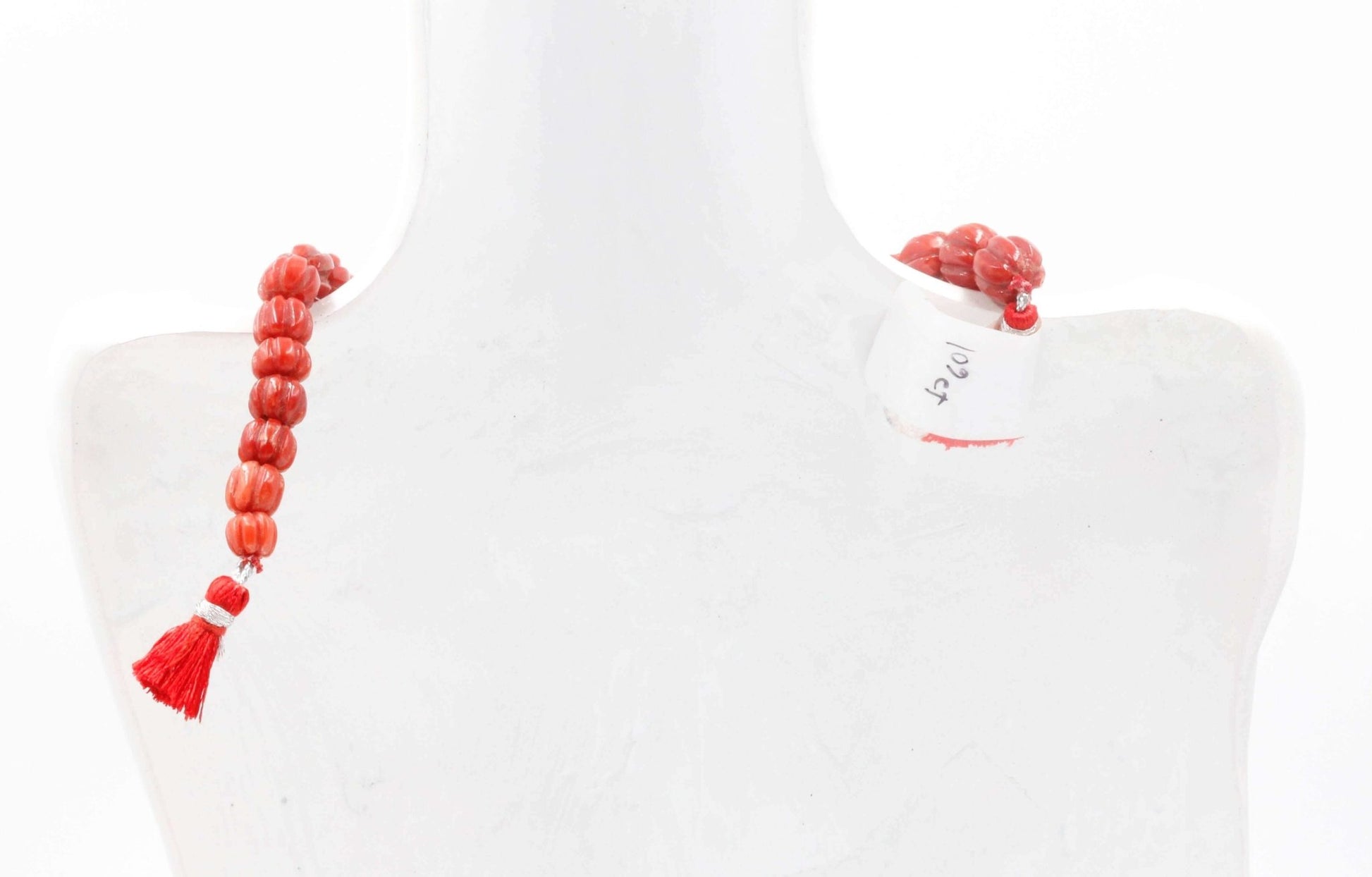 Natural Italian coral beads necklace displayed elegantly on a mannequin, showcasing its vibrant red color and design.