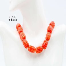 Natural orange coral beads strand showcased in a stylish necklace, highlighting vibrant pumpkin-shaped beads.
