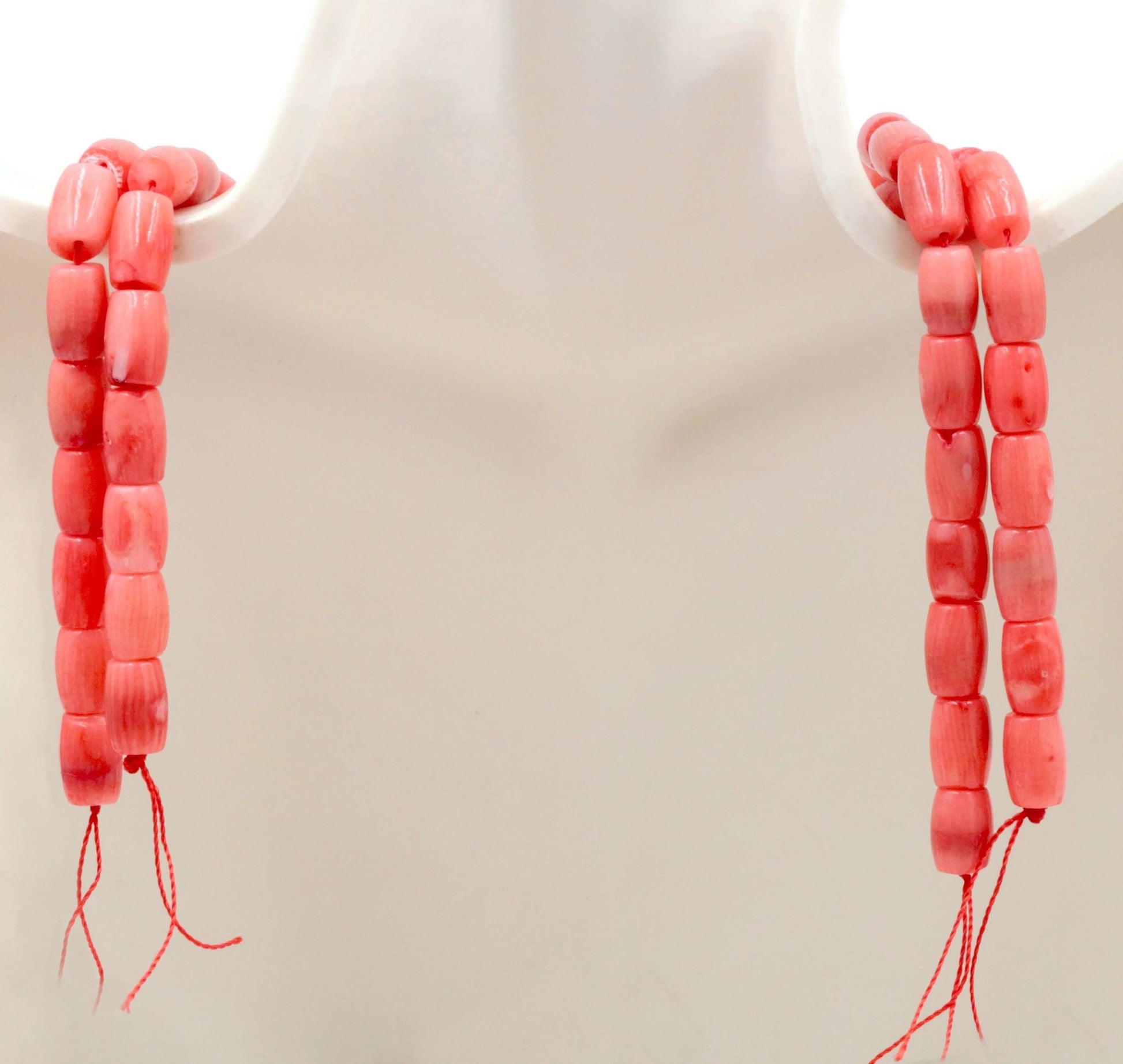 Natural pink coral beads strand showcasing semi-translucent barrel cut beads in pink color.