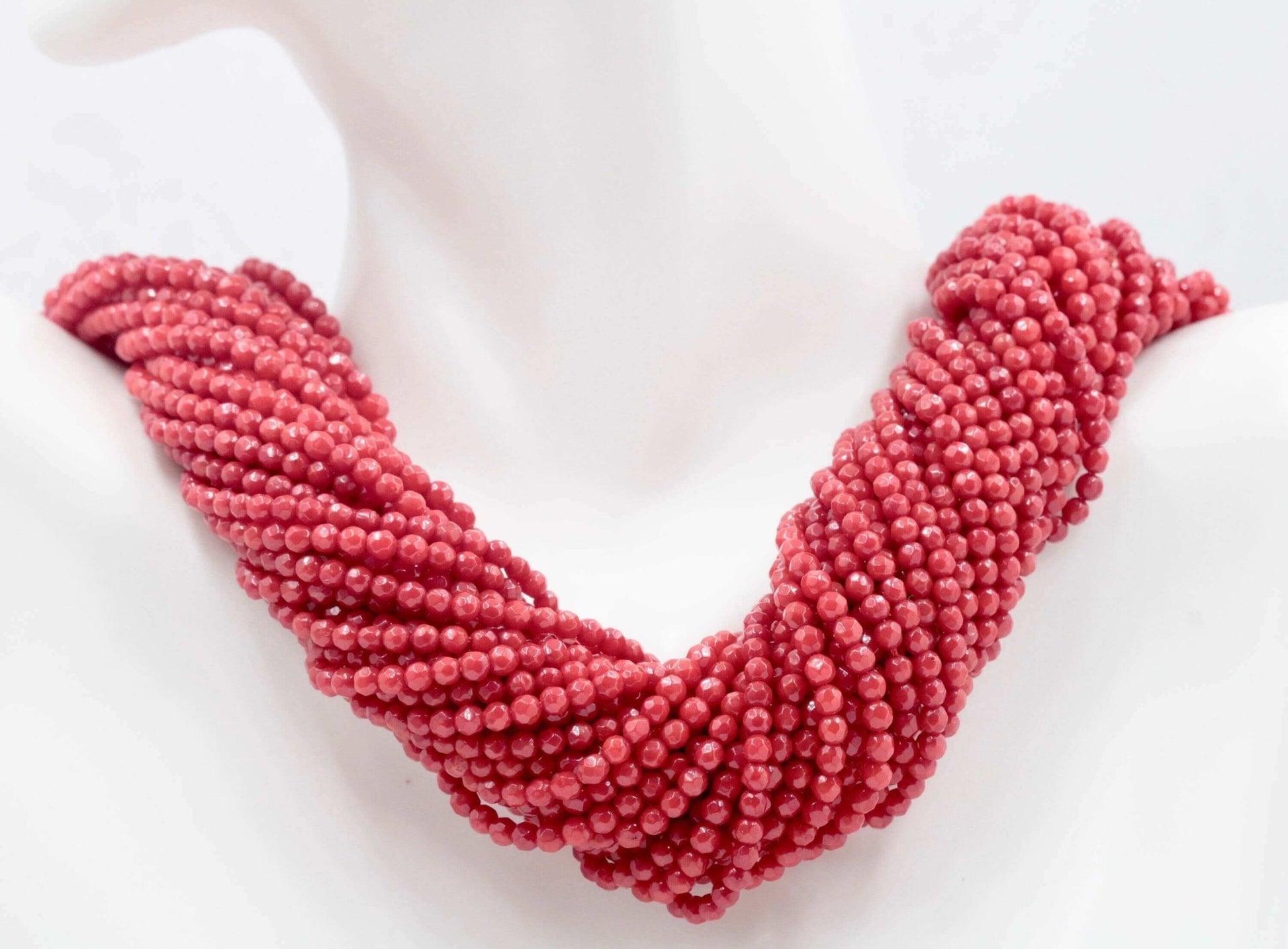 Natural red coral beads strand necklace showcasing its vibrant color and unique texture, perfect for good luck and fortune.