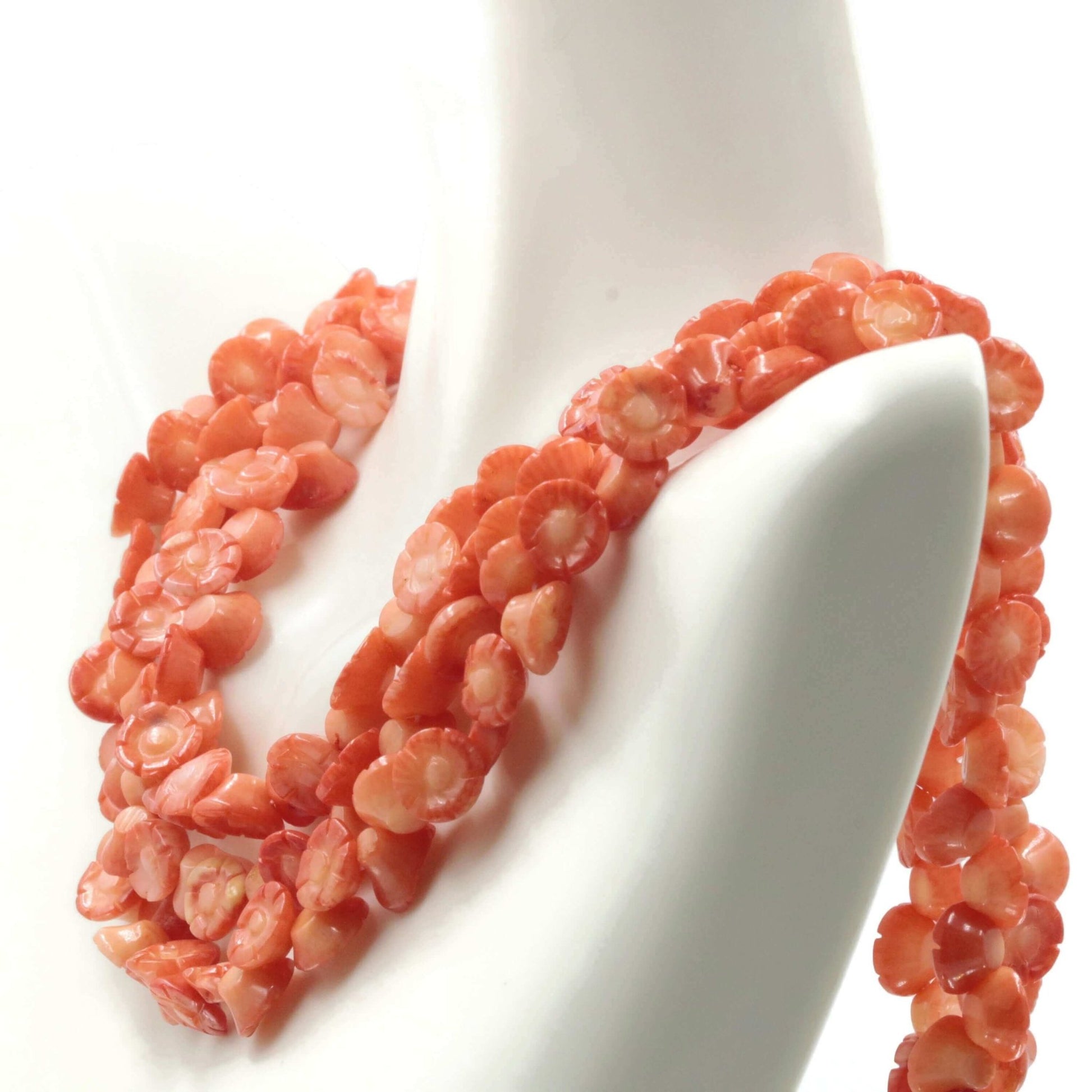 Orange Coral Flower Beads strand showcasing vibrant coral floral designs draped elegantly.